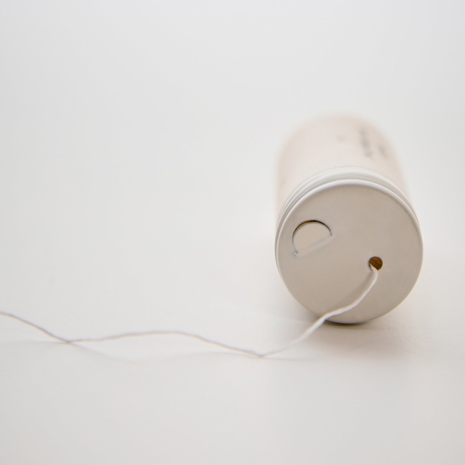 Charcoal_Brow_Mapping_Thread_Packaging lying down with thread coming out-color-white