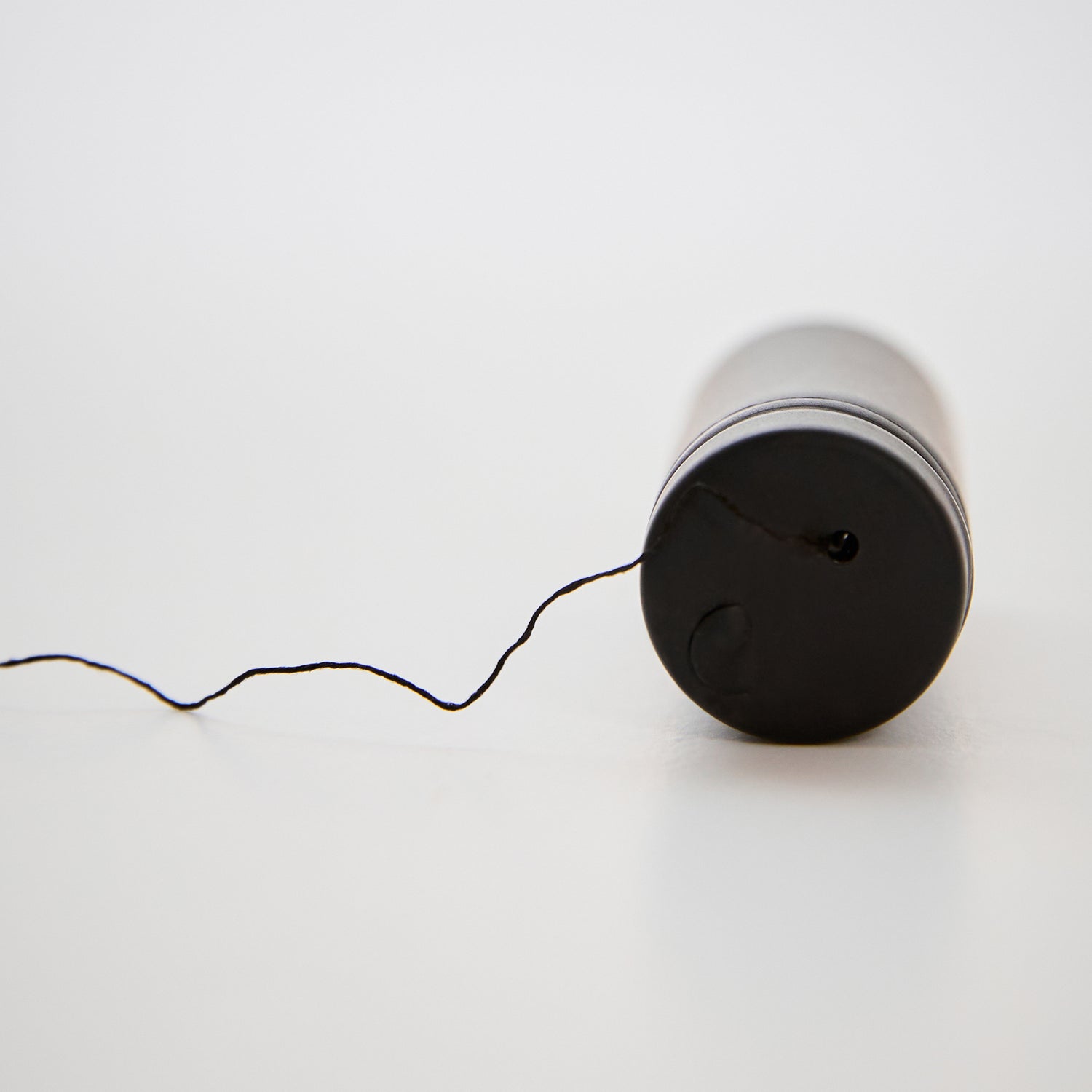 Charcoal_Brow_Mapping_Thread_Packaging lying down with thread coming out-color-black